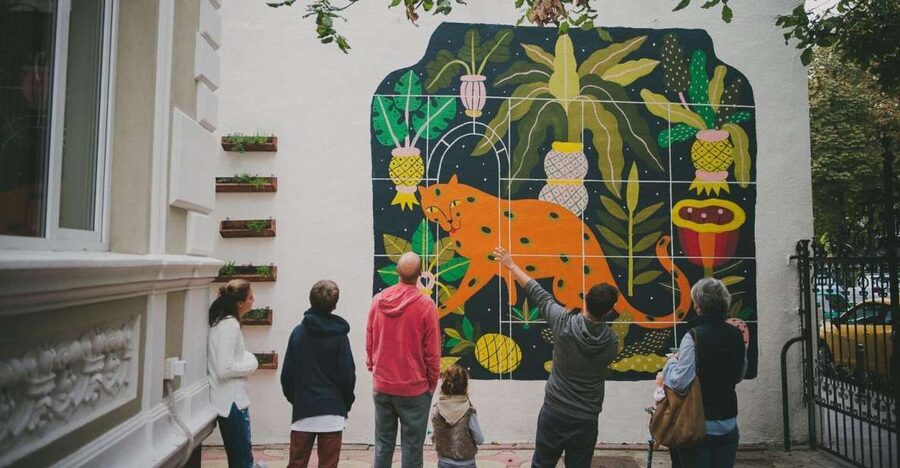 Bucharest Alternative Walking Tour - The restored Square Cat mural and Cinema Capitol Garden