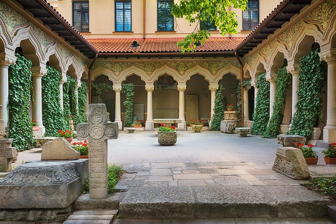 Bucharest Unveiled: A Private Walking Journey - Royal symbols at the Central University Library and Royal Palace